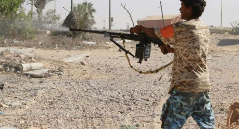 A Libyan pro-regime fighter with the Government of National Accord GNA fires at Islamic State jihadists during clashes for control of Sirte, on September 3, 2016.  By Mahmud Turkia AFPFile