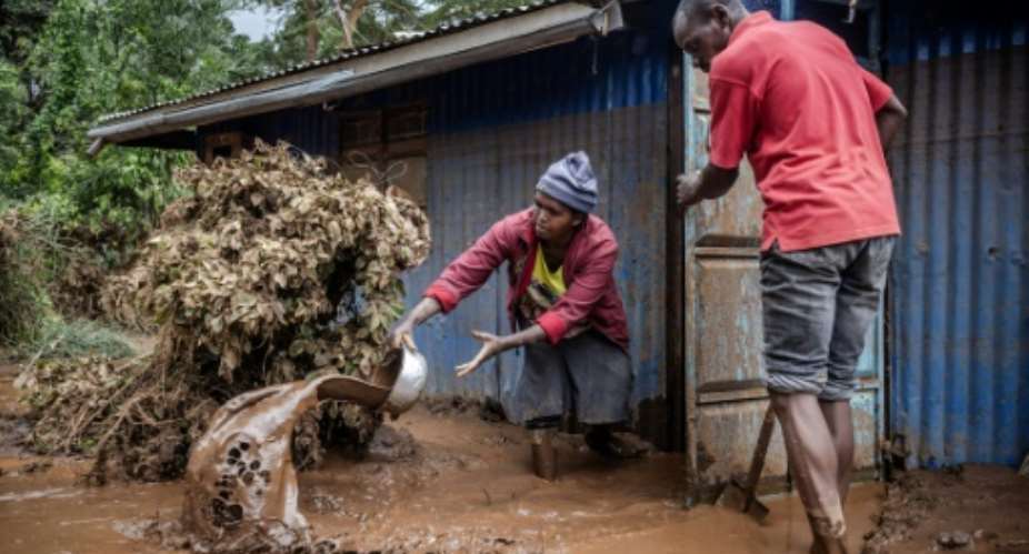 A makeshift dam burst its banks in Kenya's Rift Valley, sending torrents of water and mud gushing down a hill.  By LUIS TATO AFP