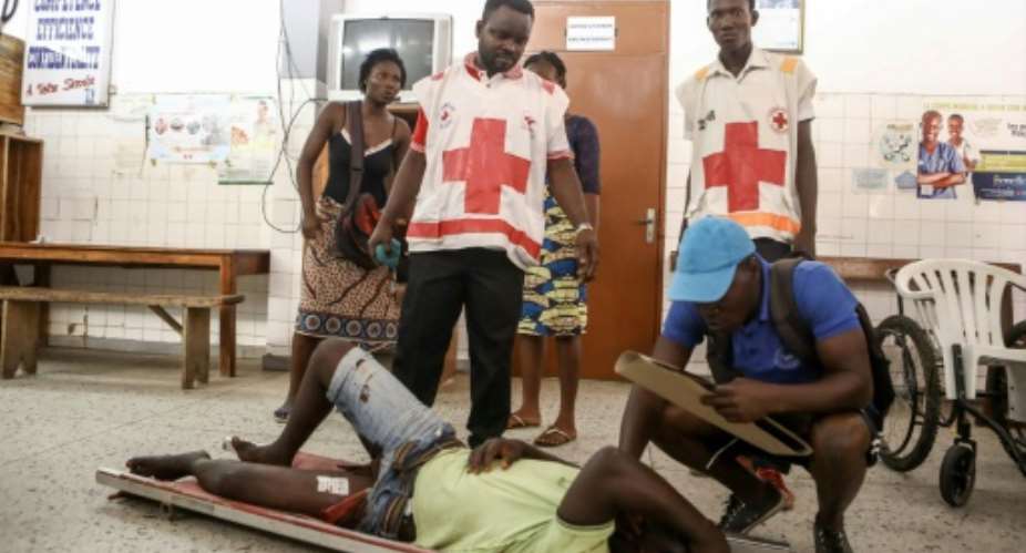 A man awaits treatment at the Secondary Hospital in Lomes Be district after he was shot in the leg when police and troops cracked down on a protest this week.  By YANICK FOLLY (AFP)