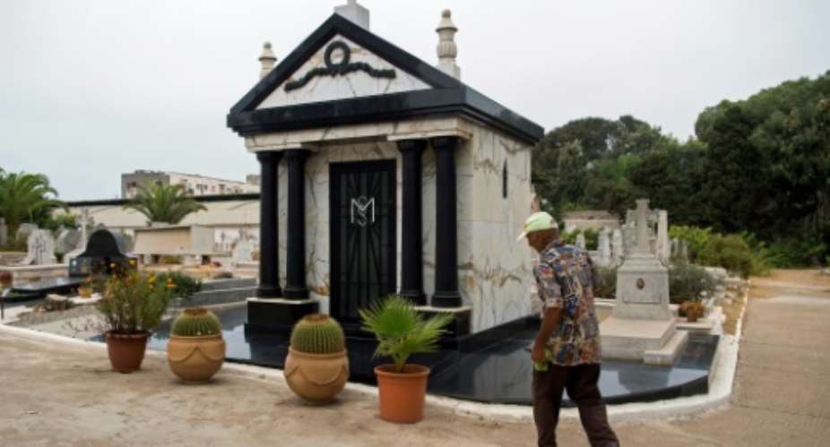 A man cleans the tomb of the late dictator Mobutu Sese Seko, the self-styled King of Zaire, on September 3, 2017.  By FADEL SENNA AFP