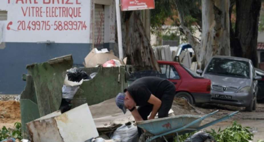 A man collects recyclable items in the impoverished Tunis suburb of Ettadhamen where unemployment is around 18 percent compared to a nationwide level of 15 percent.  By FETHI BELAID AFP