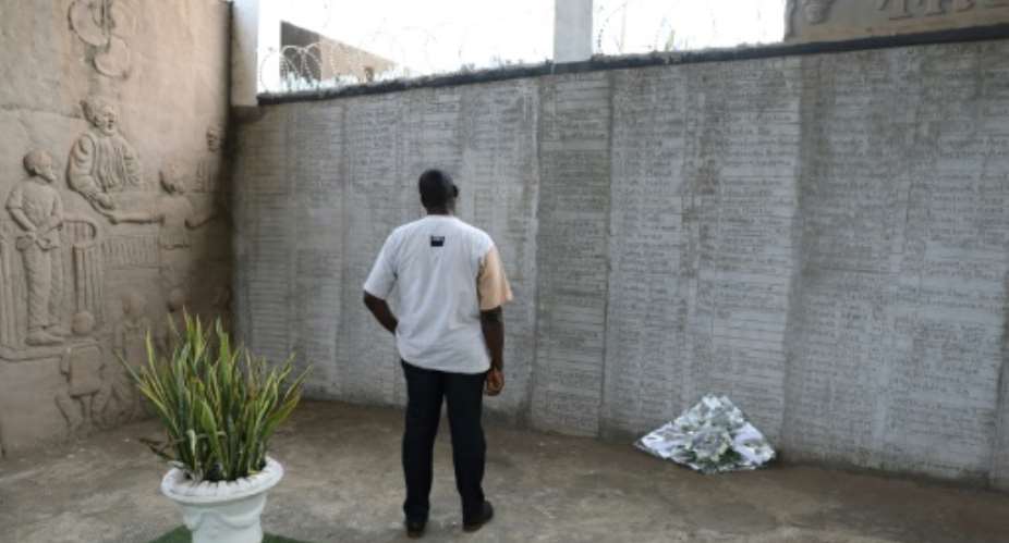 A man looks at the names of people who died during the Sierra Leone civil war at the peace museum in Freetown.  By Saidu BAH (AFP)