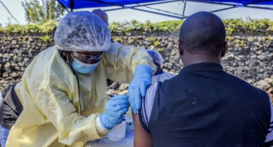 A man receives a vaccine against Ebola from a nurse outside the Afia Himbi Health Center onJuly 15, 2019 in Goma. Authorities in Democratic Republic of Congo have appealed for calm after a preacher fell ill with Ebola in the eastern city of Goma, the first recorded case of the disease in the region's urban hub in a nearly year-old epidemic..  By Pamela TULIZO AFP