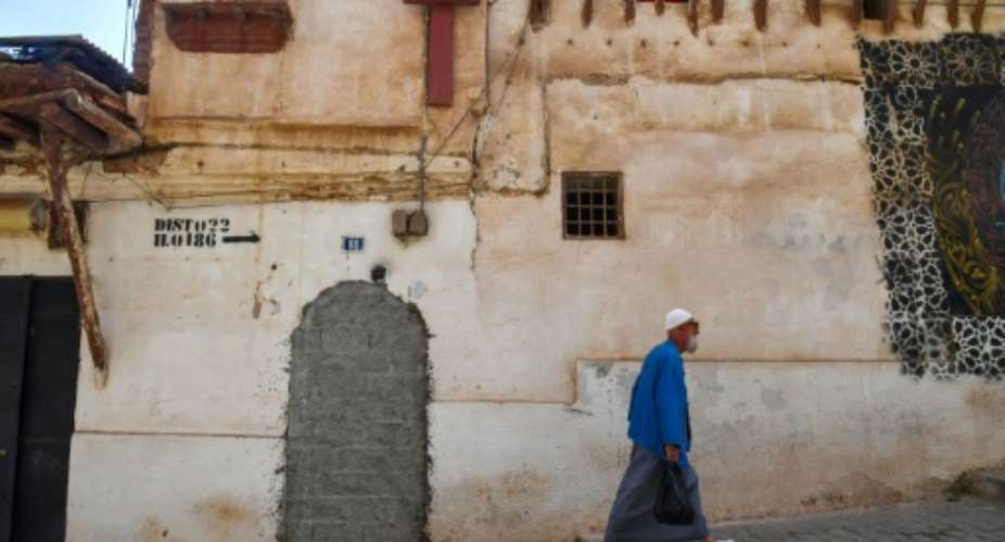 A man walks down a street in the historic Casbah of Algiers.  By RYAD KRAMDI AFP