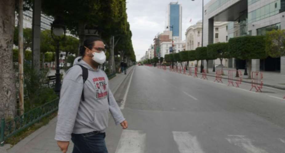 A man wears a face mask to protect against the COVID-19 disease in the Tunisian capital Tunis, where a curfew has already been imposed to stem the spread of the virus.  By FETHI BELAID AFPFile