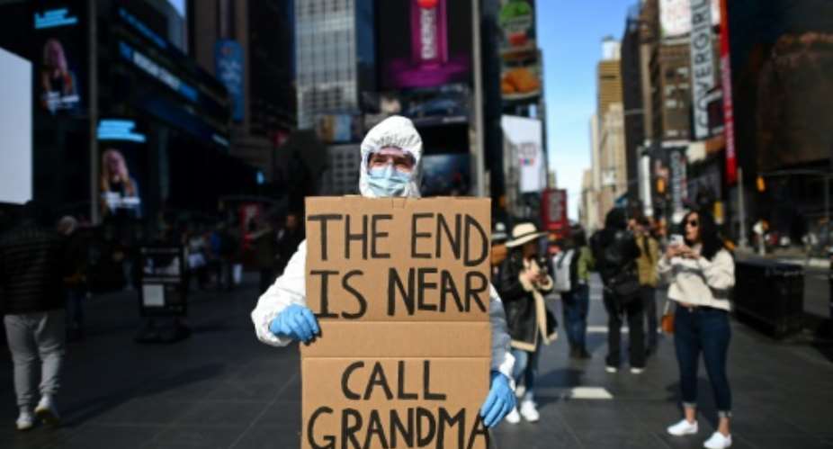 A man wears a hazmat suit in Times Square in New York City.  By Johannes EISELE (AFP)