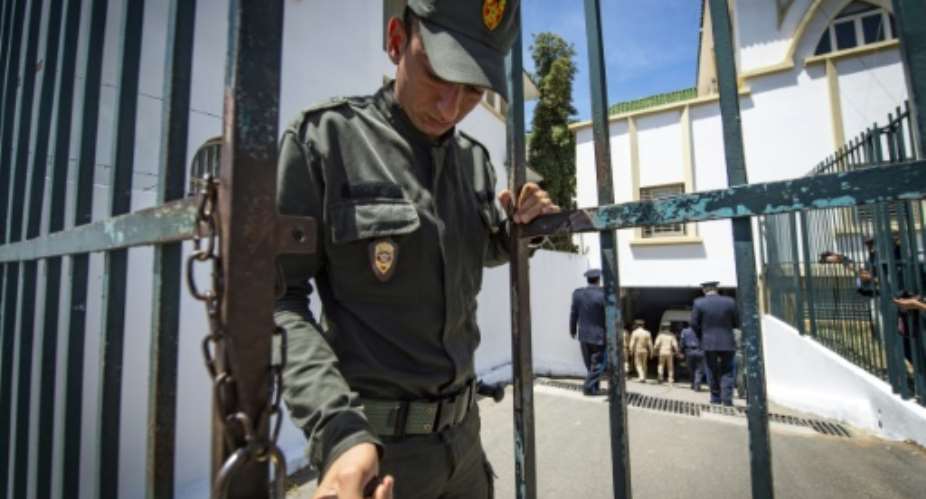 A member of Morocco's security forces locks the entrance to a court in Sale near the capital Rabat in this file picture taken on May 16, 2019.  By FADEL SENNA AFPFile