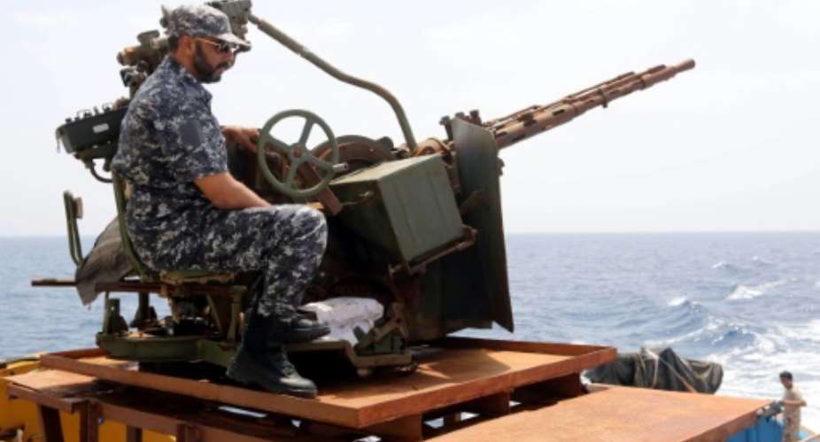 A member of the Libyan coastguards mans a machine gun on a patrol boat off the coast of Misrata on May 9, 2015.  By Mahmud Turkia AFPFile