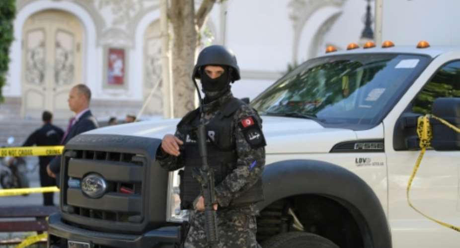 A member of the Tunisian security forces stands guard at the site of a suicide attack in the Tunisian capital Tunis on October 29, 2019.  By FETHI BELAID AFP