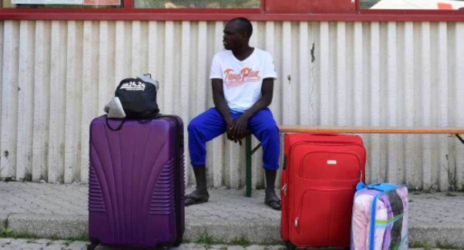 A migrant waits for a a host house at the Italian Red Cross camp in Ventimiglia on June 15, 2018.  By MIGUEL MEDINA AFP