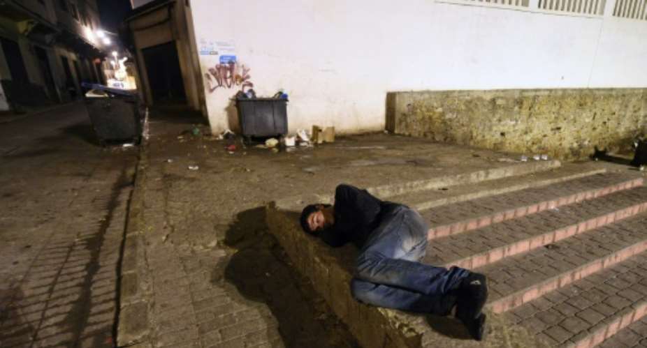 A Moroccan homeless youth sleeps in the street in the northeastern coastal city of Tangier.  By FADEL SENNA AFPFile