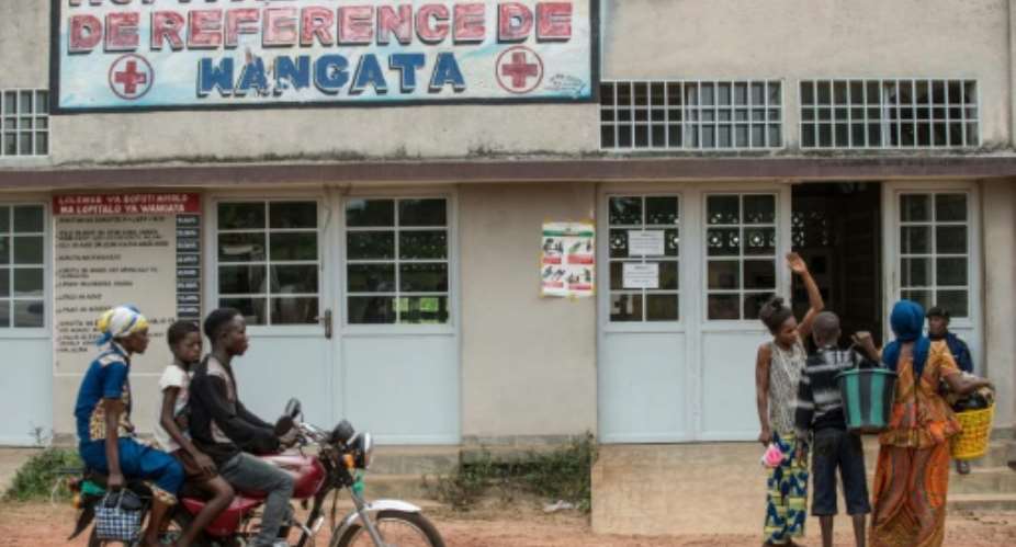A motocycle drives past the entrance of the Wangata Reference Hospital in Mbandaka, northwest of DR Congo on May 20, 2018.  By JUNIOR KANNAH AFPFile