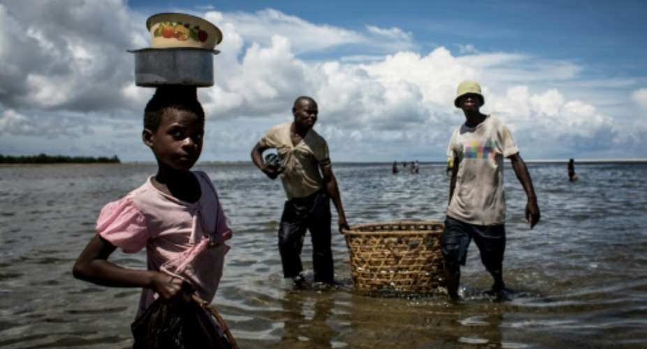 A Mozambican girl arriving to buy fish in Palma, where large deposits of natural gas where found offshore.  By John Wessels (AFP)