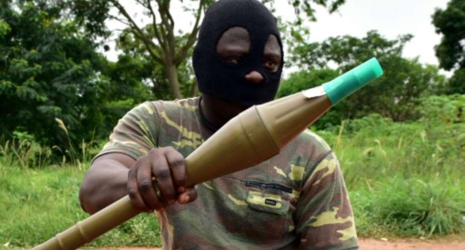 A mutinous soldier holds an RPG rocket launcher inside a military camp in Ivory Coast's second city Bouake, where the rebellion first erupted in January.  By ISSOUF SANOGO AFP