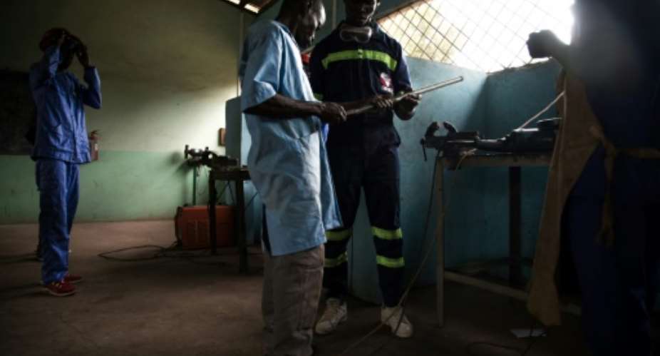 A new life: Former child soldiers learn how to weld at the Don Bosco training centre in Bangui.  By FLORENT VERGNES AFP