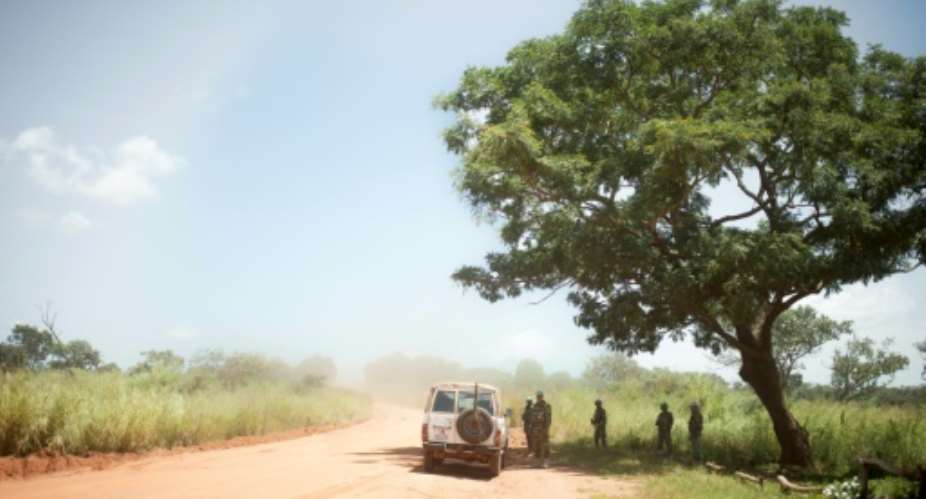 A patrol of the Bangladeshi contingent of the United Nations Multidimensional Integrated Stabilisation Mission in the Central African Republic MINUSCA wait under a tree on October 15, 2017.  By FLORENT VERGNES AFPFile