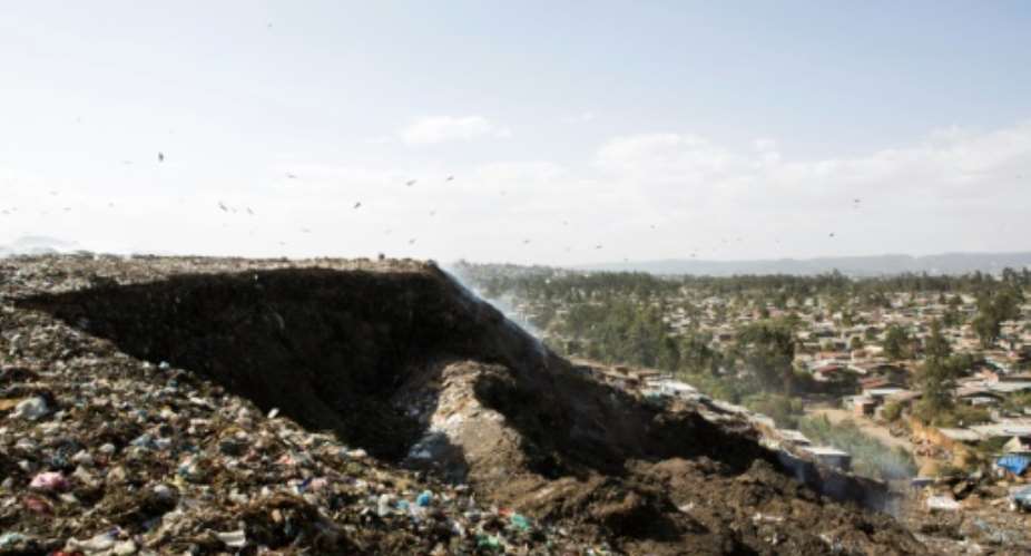 A photo taken March 12, 2017 shows a view of the main landfill of Addis Ababa on the outskirts of the city, where Ethiopia has built a power plant to convert waste into energy.  By ZACHARIAS ABUBEKER AFPFile