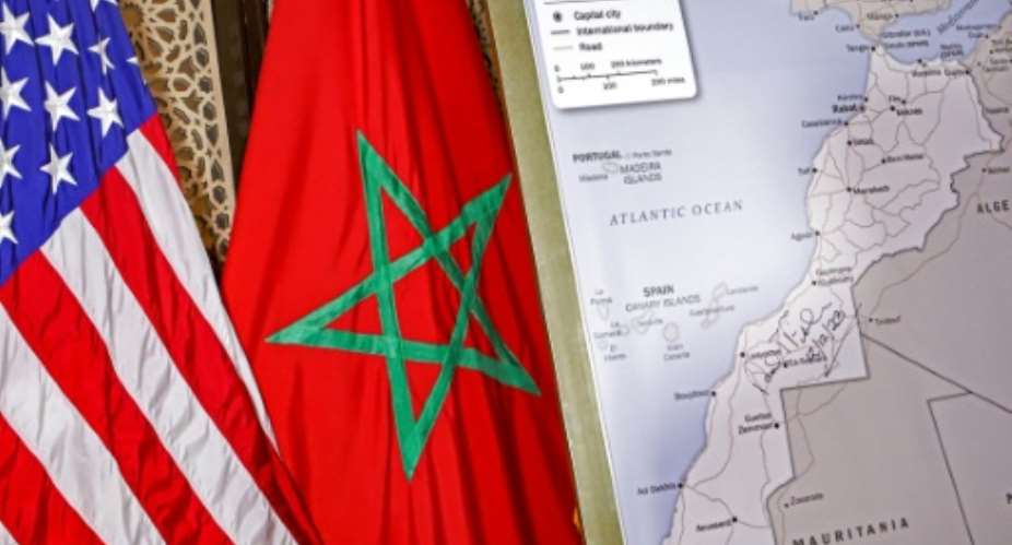 A photograph taken on December 12, 2020 shows  US and Moroccan flags next to a US State Department authorised map recognising the contested territory of Western Sahara as part of Morocco.  By - AFPFile