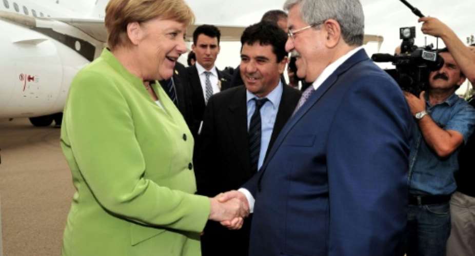 A picture from the Algerian Press Service APS shows German Chancellor Angela Merkel meeting Prime Minister Ahmed Ouyahia in Algiers on September 17, 2018.  By Handout APSAFP