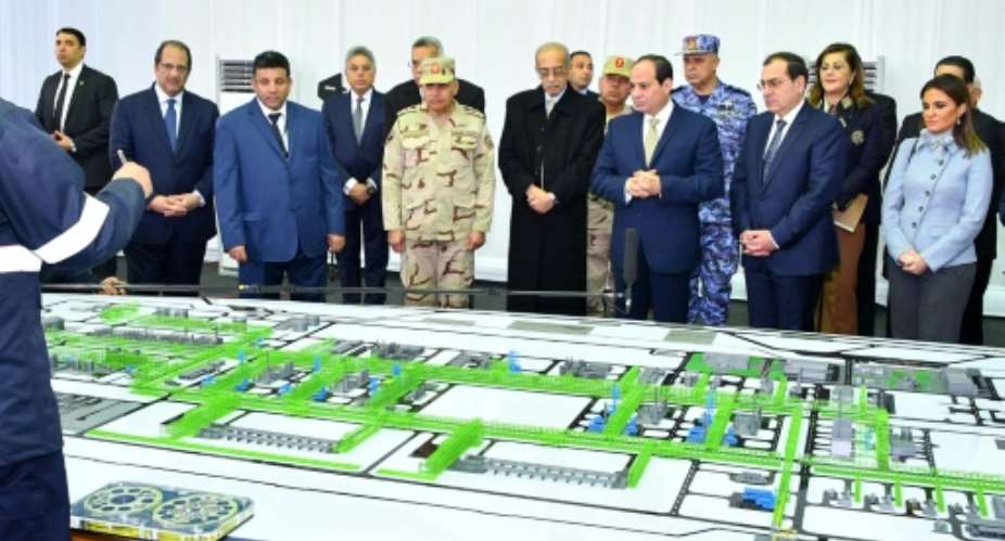 A picture released by the Egyptian Presidency on January 31, 2018 shows President Abdel Fattah al-Sisi 3rd-R looking at mockups of natural gas extraction facilities during the inauguruation of the offshore Zohr gas field.  By Handout EGYPTIAN PRESIDENCYAFP