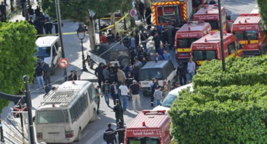 A picture shows police and firemen gathering at the site of Mondays  suicide attack in the centre of the Tunisian capital Tunis.  By FETHI BELAID (AFP)