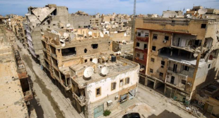 A picture taken on March 13, 2018 shows a general view of destroyed buildings in a central district in the eastern Libyan city of Benghazi..  By Abdullah DOMA AFP