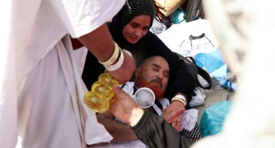 A pilgrim affected by scorching heat is helped by other Muslims in Mina, near Saudi Arabias holy city of Mecca.  By Fadel Senna (AFP)