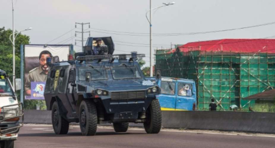 A police armored personnel carrier patrols in Kinshasa during a day of protest called by the opposition parties.  By JUNIOR D. KANNAH AFPFile