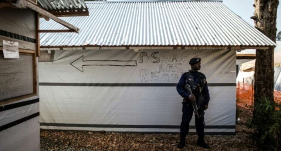 A police officer pictured March 9, 2019 stands guard inside an Ebola Treatment Centre in Butembo, North Kivu province, where the WHO says there are clear signs the spread of the virus was
