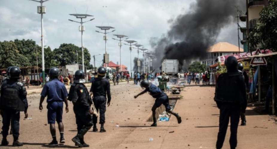 A police officer throws a stone at protesters during a mass protest on Wednesday.  By JOHN WESSELS AFPFile
