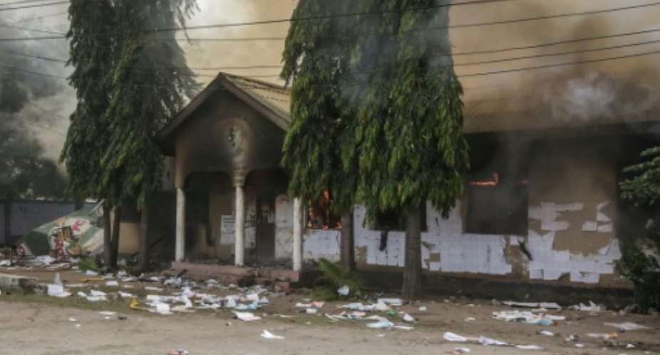 A polling station is set ablaze as clashes erupt in Dar es Salaam on October 29, 2025.  By - (AFP/File)