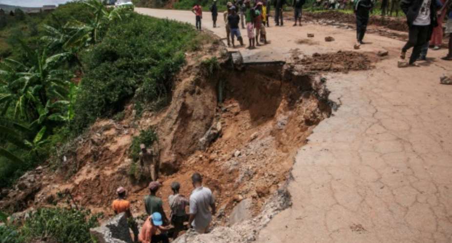 A road crumbled in the wake of Cylone Batsirai in Madagascar, which was still picking up the pieces after Tropical Storm Ana claimed 55 lives.  By RIJASOLO AFP