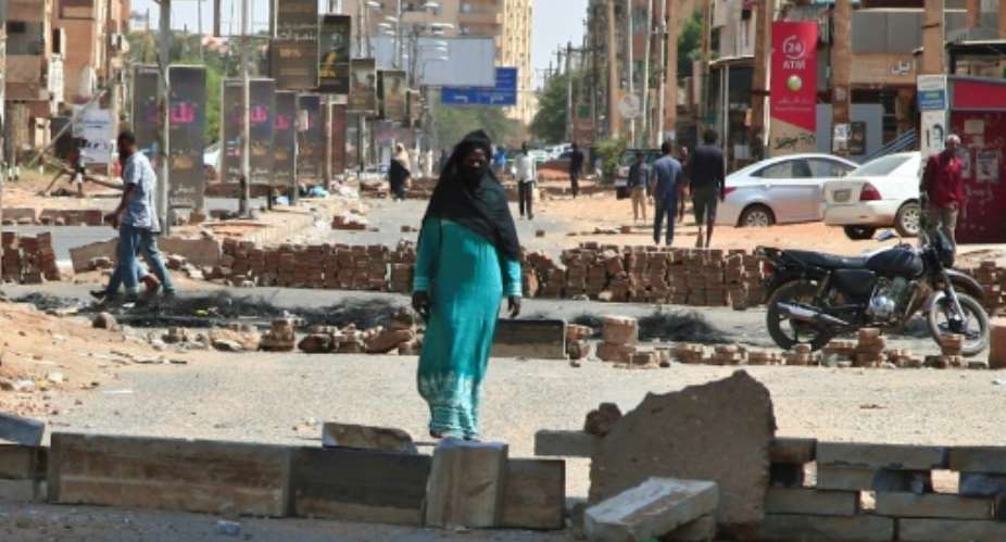A road in the Sudanese capital Khartoum barricaded by anti-coup protesters on October 27, 2021 -- security forces were clearing such blockades from major streets.  By - AFP