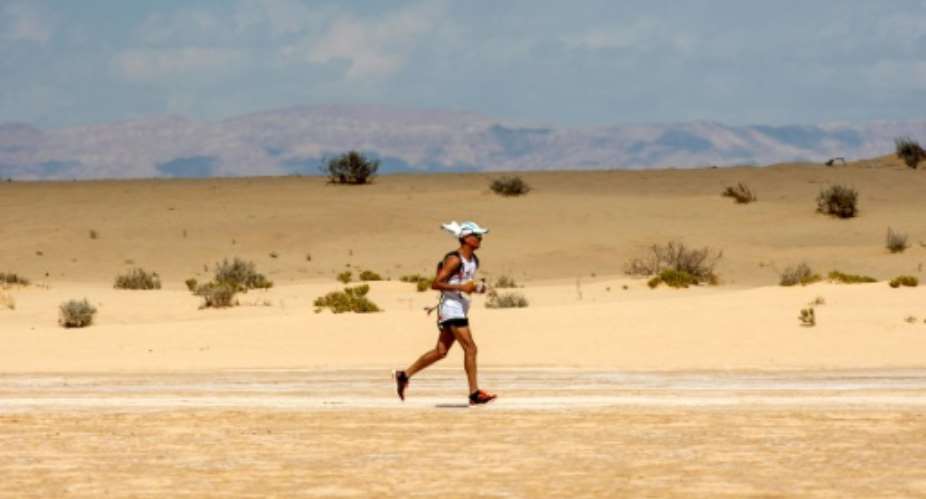 A runner competes in the Ultra Mirage El Djerid ultra-marathon in the southwestern Tunisian desert on October 7, 2017.  By AMINE LANDOULSI AFP