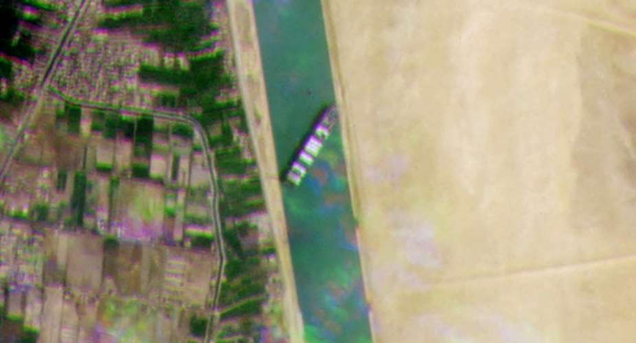 A satellite image released by Planet Labs Inc shows the Taiwan-owned container ship MV Ever Given blocking all traffic through the main channel of the Suez Canal.  By - Planet LabsAFP
