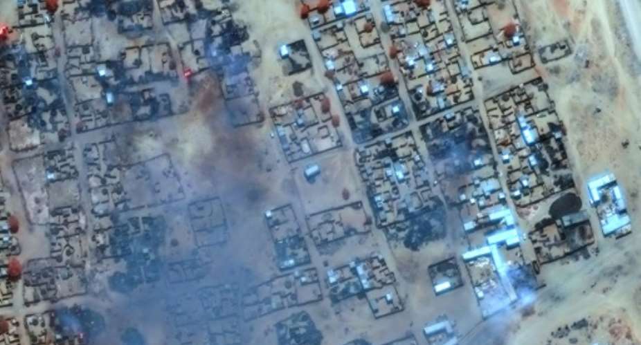 A satellite photo provided by Maxar Technologies shows smoke billowing and buildings burned in Zamzam camp near the besieged city of El-Fasher in Sudans Darfur.  By - (Satellite image 2025 Maxar Technologies/AFP/File)