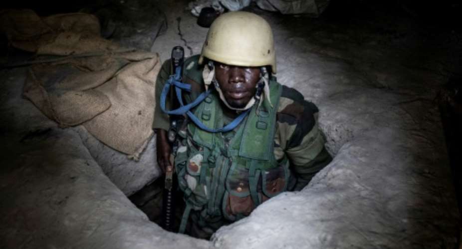 A Senegalese soldier inside a small underground bunker at a rebel base the army captured in Casamance.  By JOHN WESSELS AFP