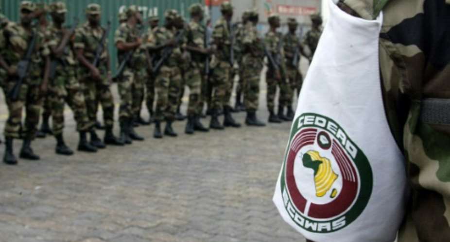 A Senegalese soldier wearing the colours of the ECOWAS force. This picture shows troops arriving in Abidjan on 18 January 2002.  By GEORGES GOBET (AFP/File)