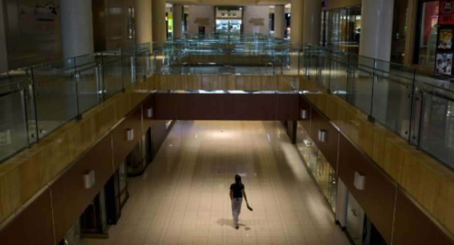 A shopper walks through The Galleria mall in Houston on the first day since the partial lifting of coronavirus lockdown measures.  By Mark Felix AFP