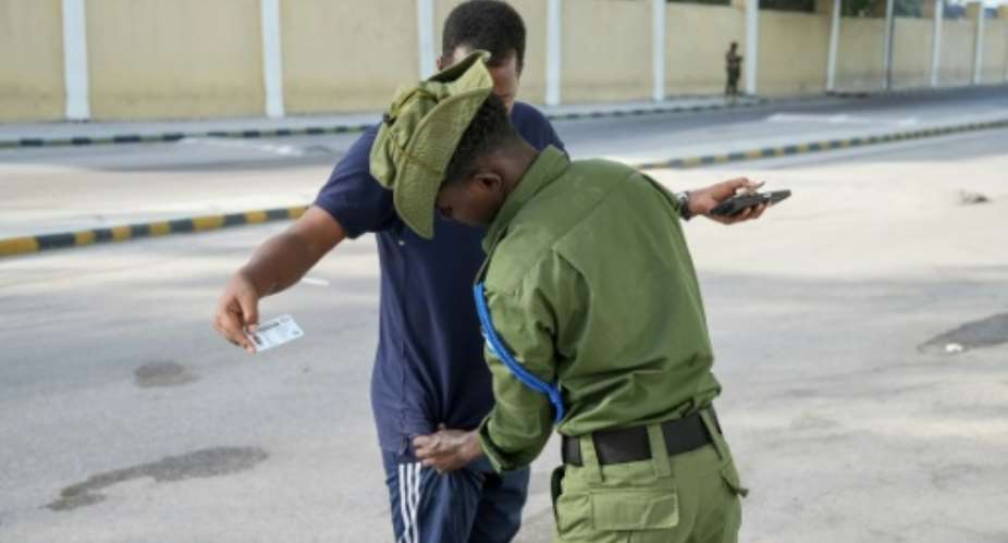 A soldier frisks a voter during the Mogadishu regions local polls.  By Hassan Ali ELMI (AFP)