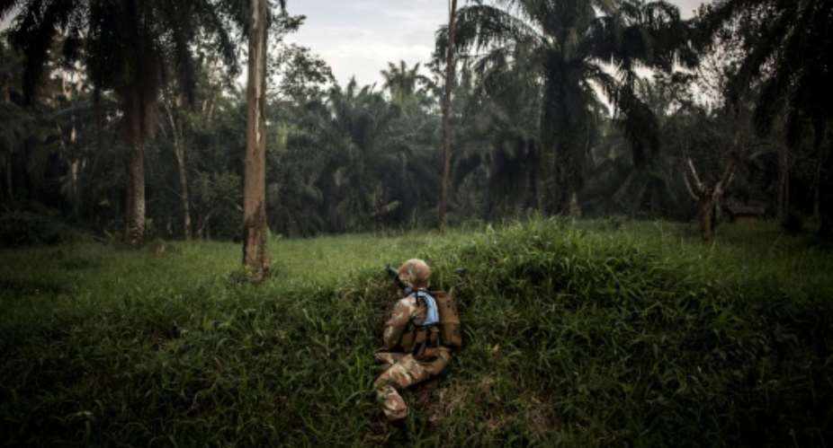 A soldier from the UN's DR Congo mission patrols for members of the ADF militia, which is thought to have killed more than 700 civilians since 2014.  By JOHN WESSELS AFP