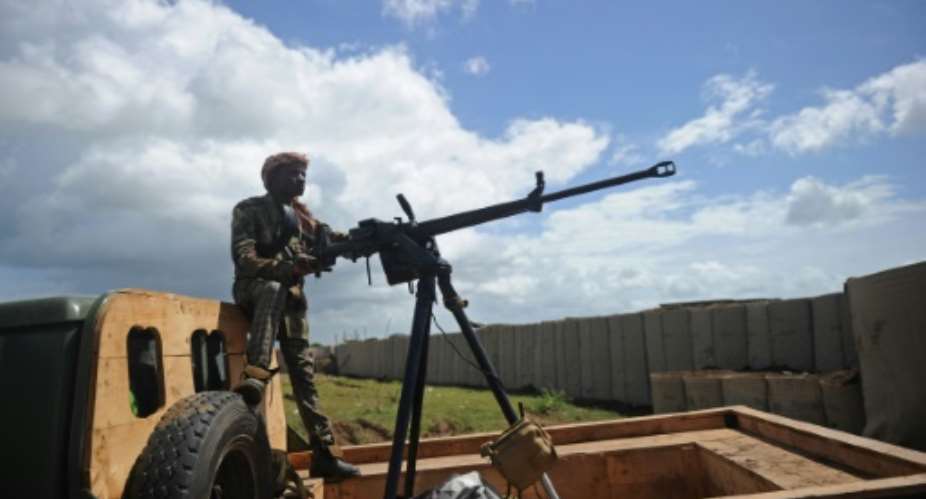 A Somali soldier with a vehicle-mounted heavy machine gun keeps an eye out for danger at the Sanguuni military base south of the capital Mogadishu.  By Mohamed ABDIWAHAB AFPFile