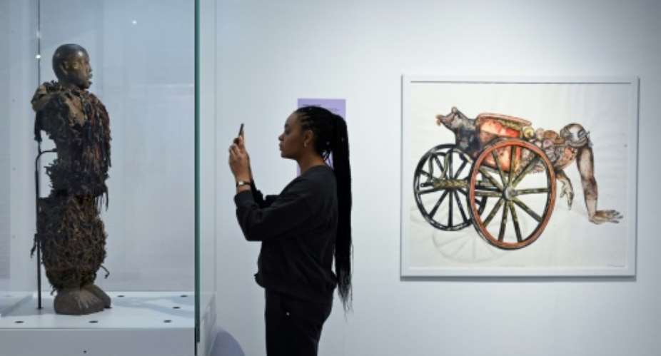 A statue stolen from a Congolose chief stands in the museum as A Symbol of Stolen Art as part of an exhibition highlighting the colonial-era plunder.  By JOHN THYS (AFP)