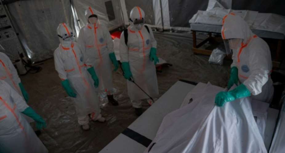 A team of doctors with the body of a man in a bodybag who died from Ebola in Bunia, eastern DR Congo.  By Jospin Mwisha (AFP)