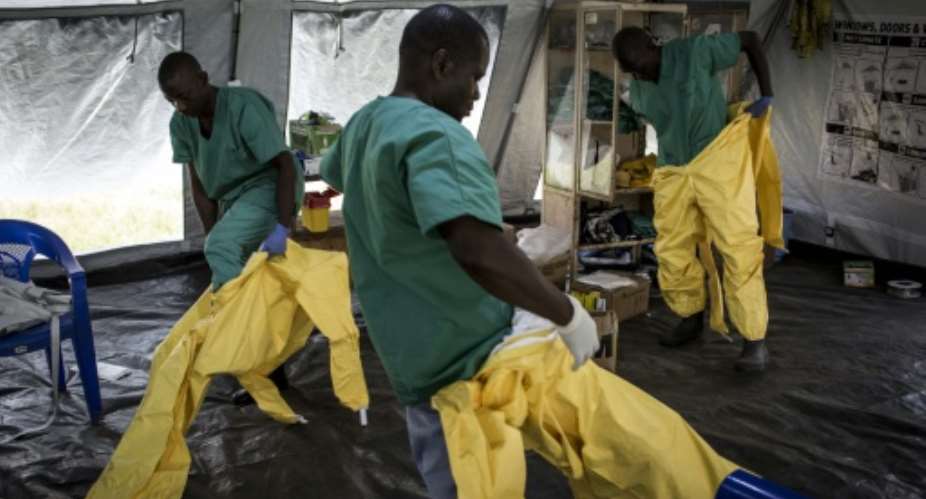 A team of medical workers are seen putting on their Personal Protective Equipment PPE ahead of entering an Ebola Treatment Centre run by The Alliance for International Medical Action ALIMA on August 11, 2018 in Beni, northeastern DRC.  By John WESSELS AFPFile