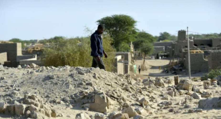 A Timbuktu resident walks in the ruins of the Sidi Moctar shrine destroyed by Islamists, in January 2013.  By ERIC FEFERBERG AFPFile