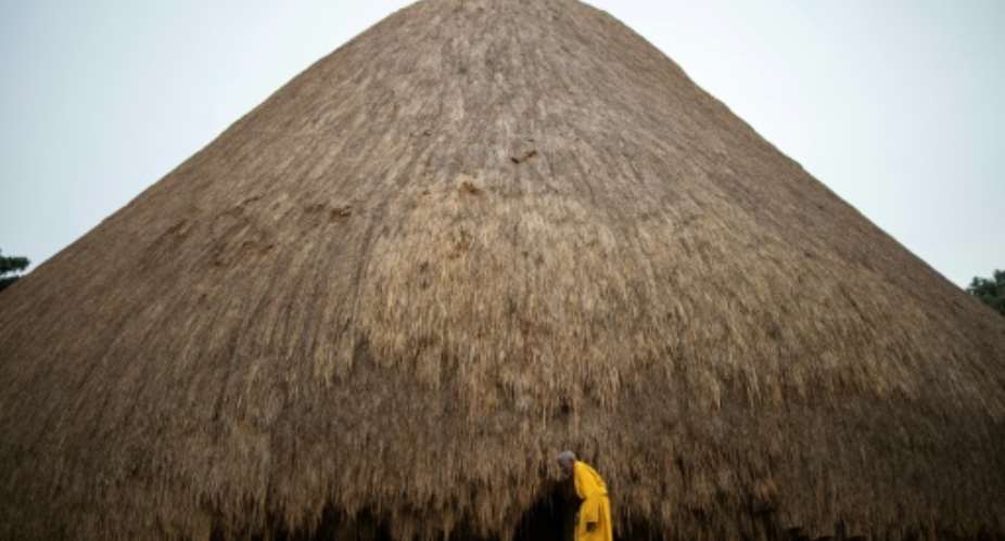 A traditional guard stands outside a building at the Kasubi Royal Tombs in Kampala, Uganda.  By Stuart Tibaweswa AFPFile