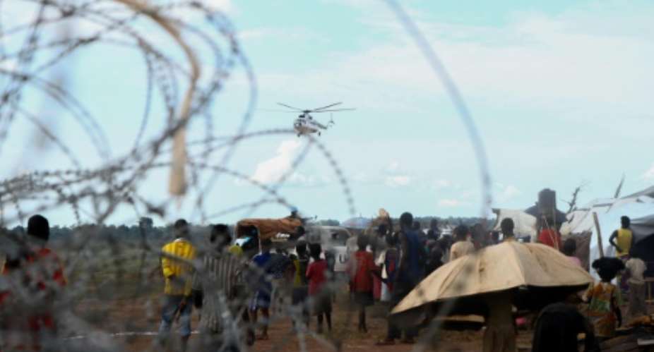 A UN helicopter flies over the newly formed camp for internally displaced people, in Kaga Bandoro, on October 18, 2016.  By Edouard Dropsy AFPFile