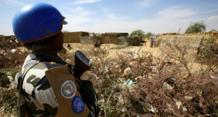 A United Nations peacekeeper stands guard at a UN refugee camp in the city of Nyala, in South Darfur, on January 9, 2017.  By Ashraf SHAZLY AFPFile