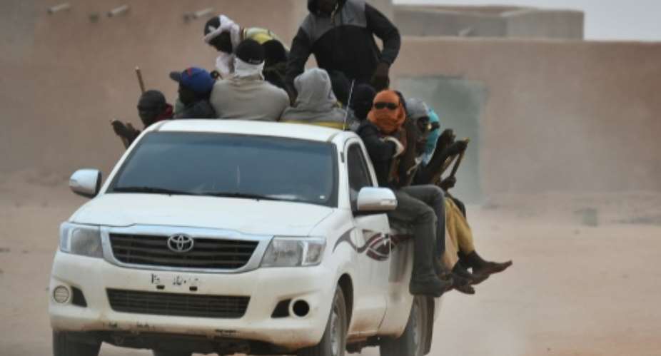 A vehicle carrying migrants travels through Agadez, Niger, en route to Libya in June 2015.  By ISSOUF SANOGO AFPFile